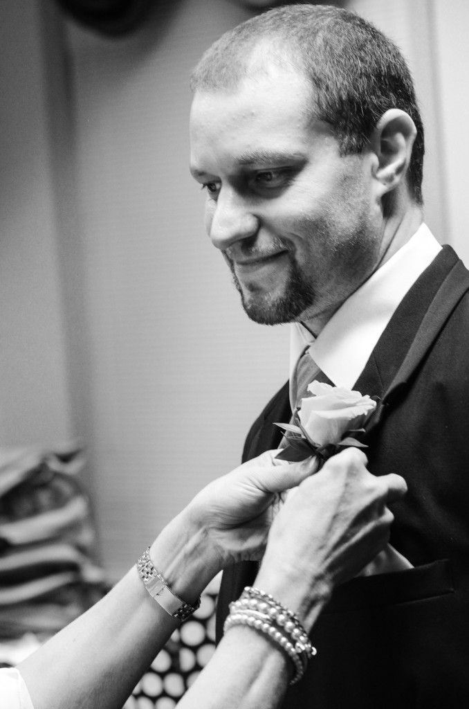 Groomsman getting pinned, black and white wedding photography Groomsman getting pinned, black and white wedding photography